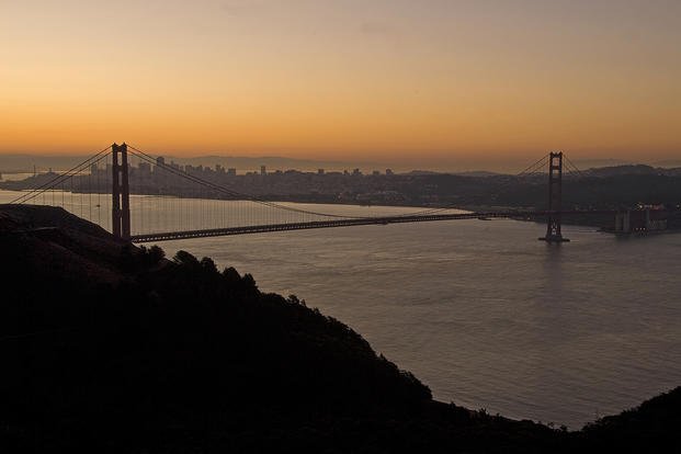 Sun rises over Golden Gate Bridge.