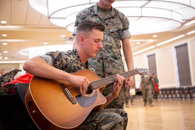 A Marine plays the guitar as a way to manage everyday stress.