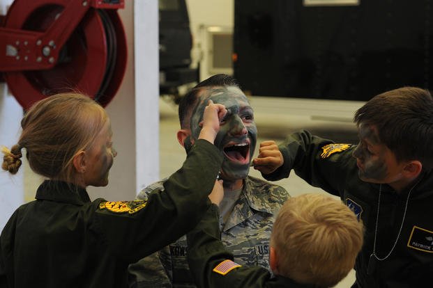 Airman gets face painted.