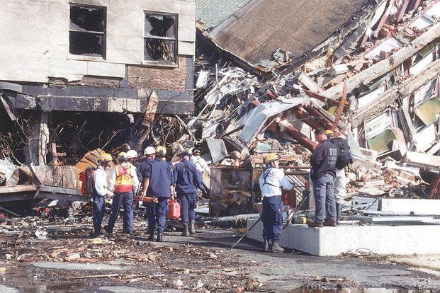 FBI personnel and emergency response teams work near the collapsed E Ring, 11 September 2001.