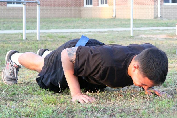 Private performs push-ups during physical fitness competition.