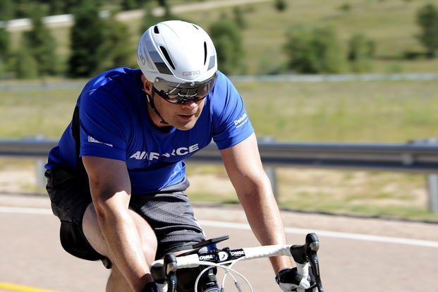 An airman rides his bicycle to work as part of his cardio program.