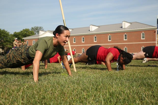 Marine performs push-ups during a physical training session.