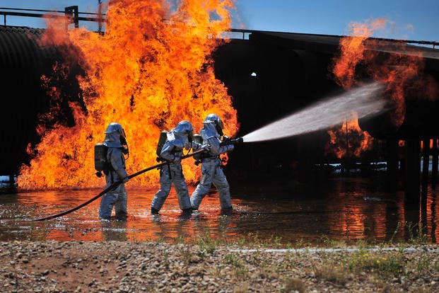 Firefighters work to extinguish a simulated engine fire at Cannon Air Force Base