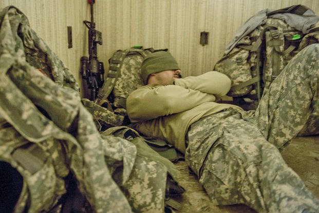 Soldier rests before his flight out of Louisiana.