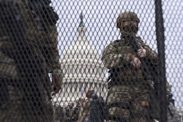 Members of the National Guard stand guard outside the U.S. Capitol