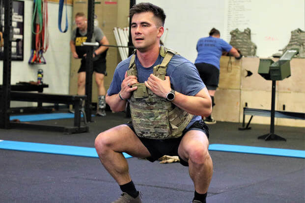 National Guardsman performs an air squat.