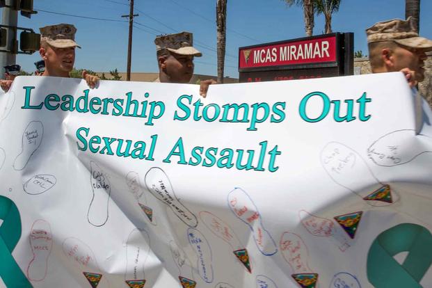 Marines walk along the streets to raise awareness about sexual assault