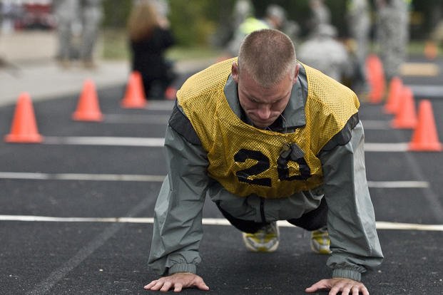 A military policeman does push-ups during the Army Best Warrior competition.