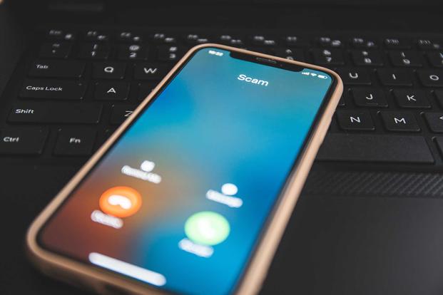 Mobile phone receiving call from scam caller