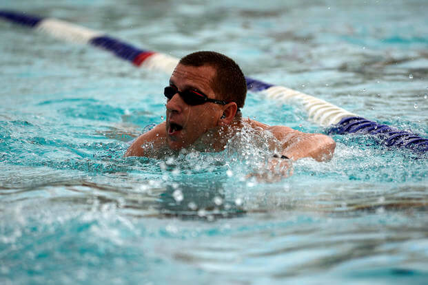 A participant completes the swim portion of a triathlon at Luke Air Force Base in Arizona.