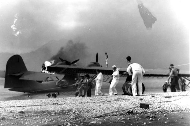 Sailors attempt to save a burning PBY at Naval Air Station, Kaneohe Bay, Oahu, during the Japanese air raid.