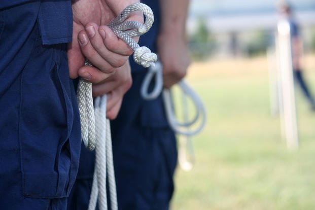 A Coast Guard recruit awaits their turn to perform a knot-tying practical.