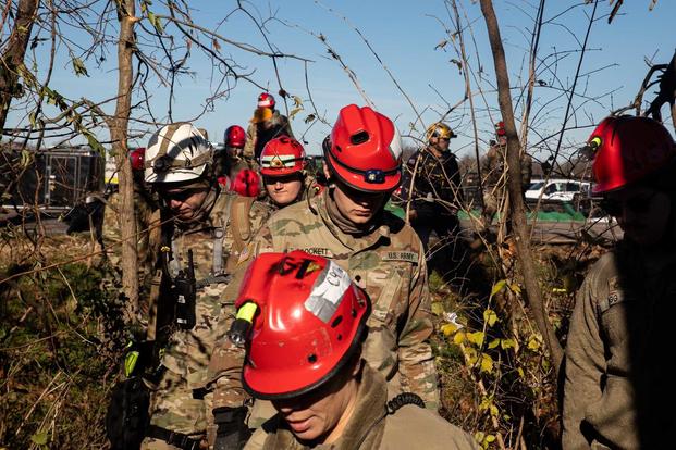 Guardsmen continue search and rescue missions in Mayfield, Ky.