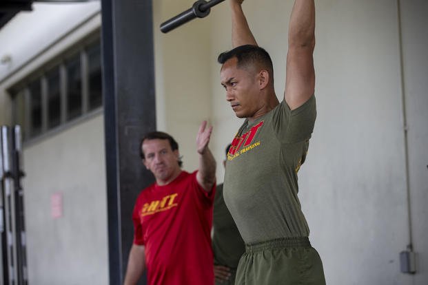 A Marine executes a push press.