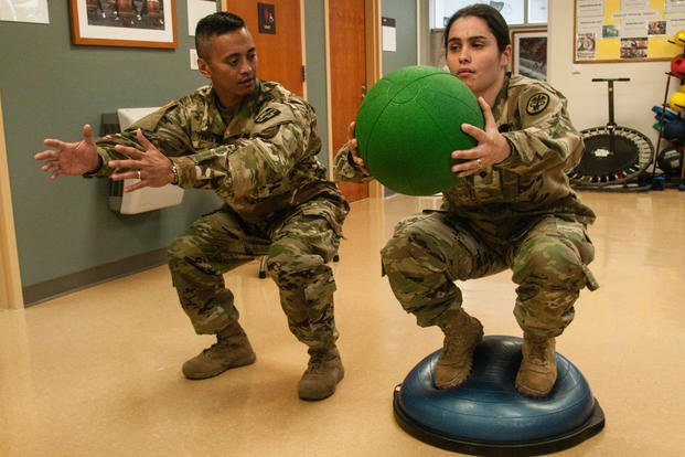 A patient works on a stability ball exercise during a physical therapy session.