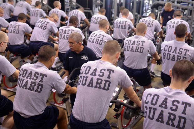 Coast Guard recruits learn how to ride a stationary bike properly.