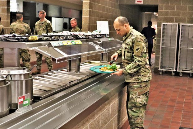 A soldier fills his plate at Fort McCoy.