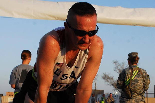 An Army sergeant catches his breath after winning the Sept. 11 10K run at Adder in Nasayra, Iraq.