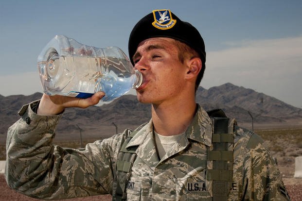 An airman drinks water in front of Nellis Air Force Base, Nevada. 