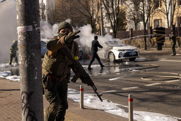 Ukrainian soldiers take positions outside a military facility in Kyiv. 