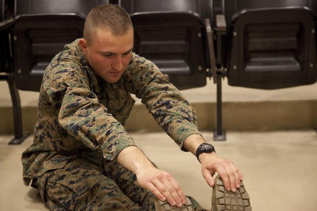 A Marine stretches before a squad competition aboard Camp Geiger, N.C.