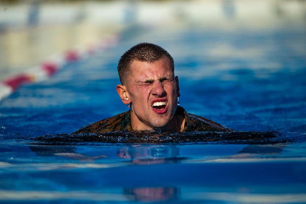 A Marine swims 1,400 meters during a squad competition.