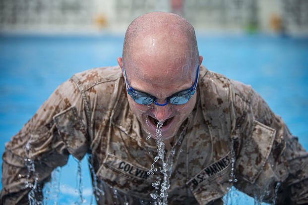 A Marine conducts push-ups during a water survival advanced course.
