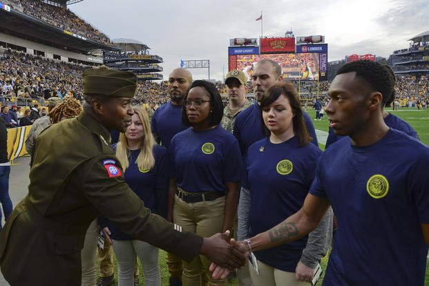 Future sailors are congratulated after taking the oath of enlistment at Heinz Field.