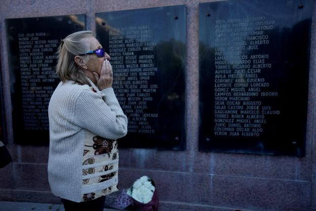 A woman looks at engraved names of Argentinean soldiers killed during the 1982 Falklands war. 