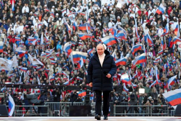 Russian President Vladimir Putin walks into a stadium in Moscow, Russia.