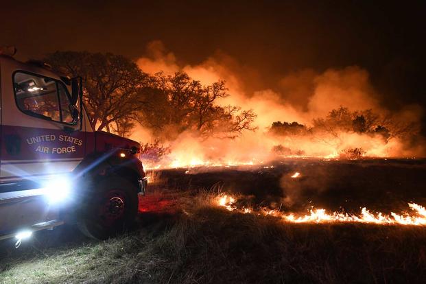 U.S. Air Force fire truck responds to a wildfire at Joint Base San Antonio.
