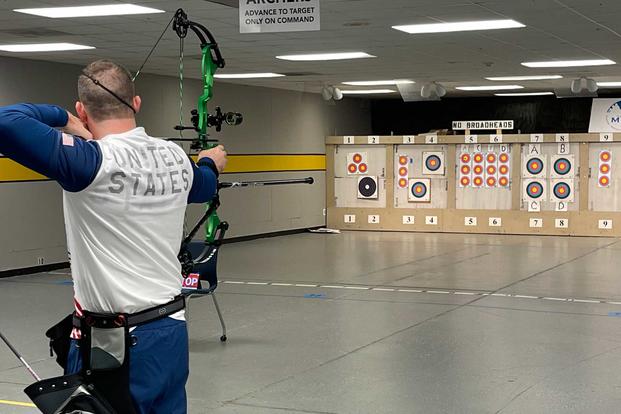 Brett Campfield trains with his bow for the Invictus Games.