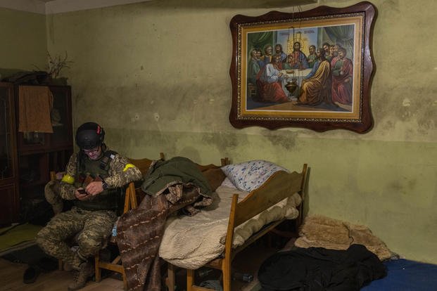 A Ukrainian National Guard soldier takes a break in a house used as temporary base.