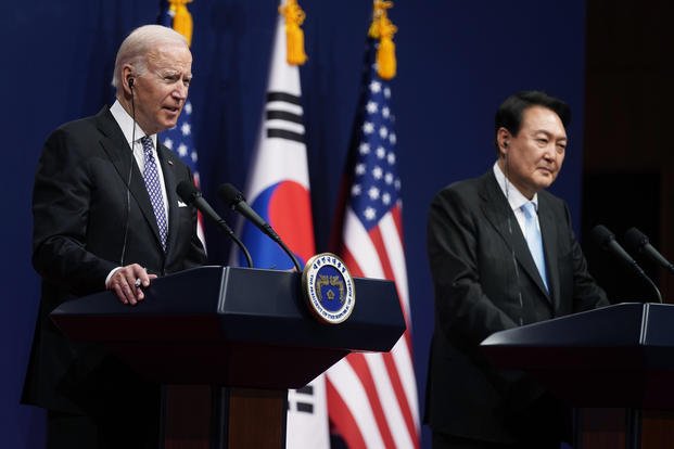 President Joe Biden speaks as South Korean President Yoon Suk Yeol listens during a news conference.