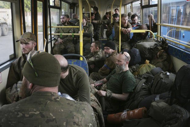 Ukrainian servicemen sit in a bus after they were evacuated from Mariupol's Azovstal steel plant