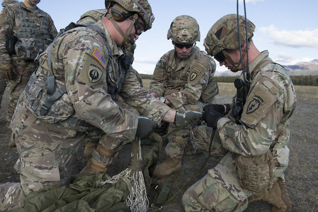 Soldiers with the 4th Infantry Brigade Combat Team (Airborne), 25th Infantry Division, U.S. Army Alaska, recover a parachute.