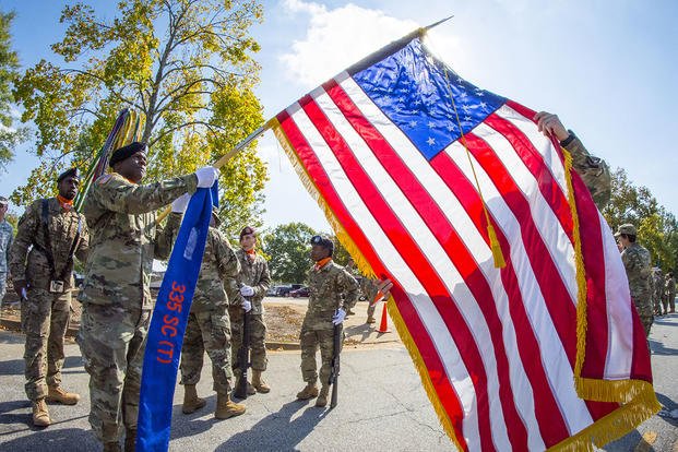U.S. Army Reserve Sgt. 1st Class Daniel Bulla, and Sgt. Gerald Willis case the U.S. flag at Fort McPherson, Ga.