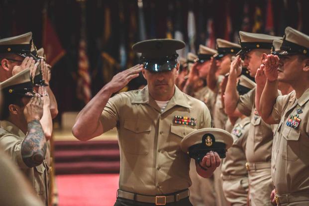 A U.S. Marine marches during a Chief Petty Officer Pinning Ceremony.