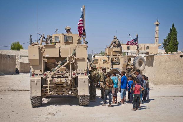 U.S. military convoy conducting a patrol outside Manbij, Syria.