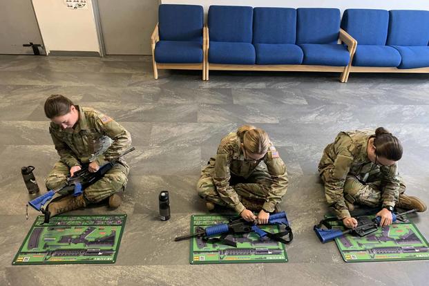 Guardians assemble and disassemble an M4 carbine at boot camp.