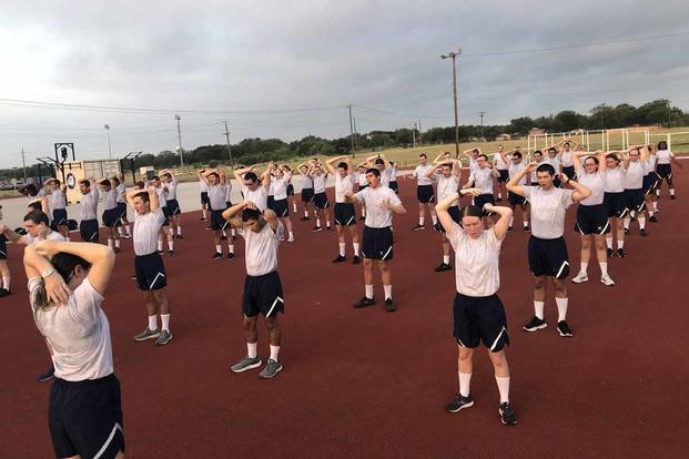 Guardians stretch after finishing up their physical training assessments.