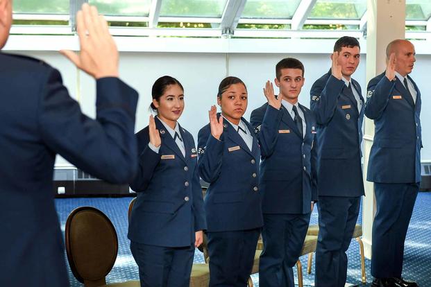 Airmen recite the oath of office.