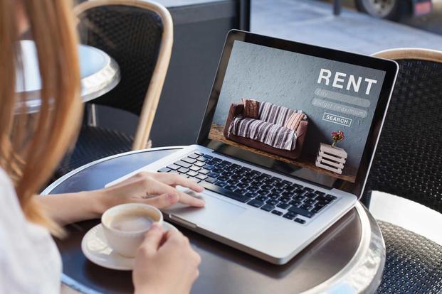 Woman examining rental homes online