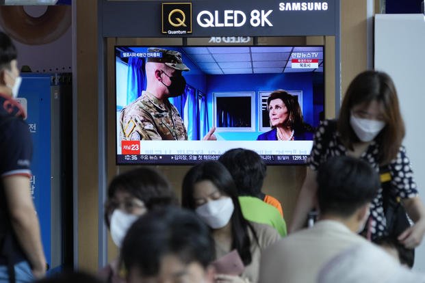 A TV inside a train station shows U.S. House Speaker Nancy Pelosi visiting South Korea.