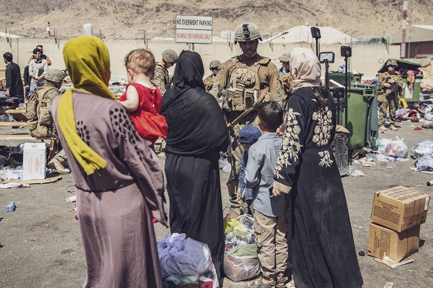 U.S. Marines with the 24th Marine Expeditionary Unit (MEU) process evacuees as they go through the Evacuation Control Center (ECC) during an evacuation at Hamid Karzai International Airport, Kabul, Afghanistan, Aug. 28, 2021.