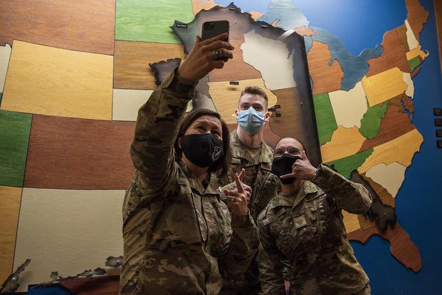 Chief Master Sergeant of the Air Force JoAnne S. Bass pauses for a photograph with airmen at Joint Base Elmendorf-Richardson, Alaska.
