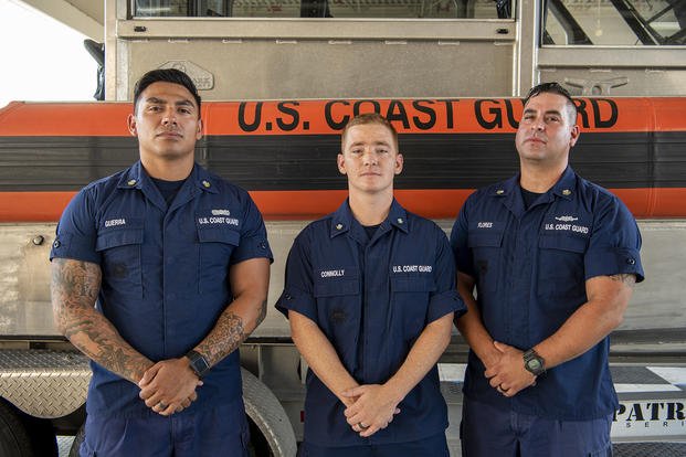 Petty Officer 2nd Class Jarrett Guerra, Petty Officer 3rd Class Corey Connolly and Petty Officer 2nd Class Jake Flores, members of Coast Guard Maritime Safety & Security Team Houston, pose for a photo in the unit’s boat shed in Houston, July 14, 2022. 