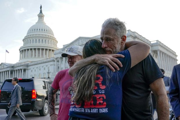 Veteran advocate and comedian Jon Stewart hugs Rosie Torres, co-founder of Burn Pits 360, a nonprofit that pushed for legislation in Congress that would expand health care for millions of veterans exposed to toxins from burn pits used to dispose of waste overseas. 
