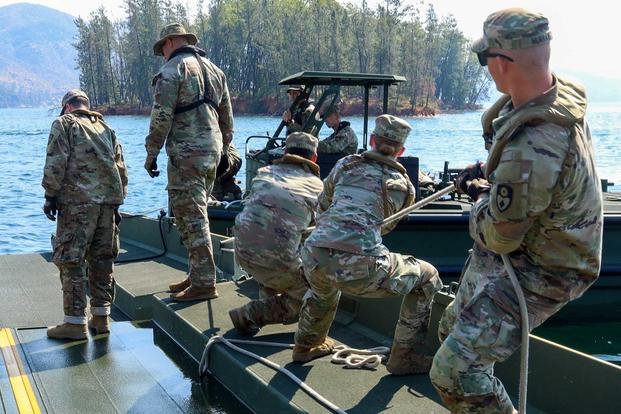 Soldier pull M30 boat into the dock on Whiskeytown Lake, California.